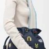 Cats medium Flamenco-clutch van geborduurd denim Cats medium Flamenco-clutch van geborduurd denim